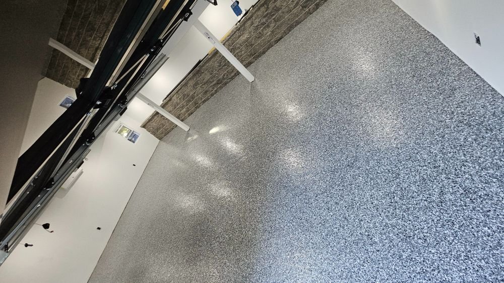 Glossy epoxy flake floor reflecting overhead lights
